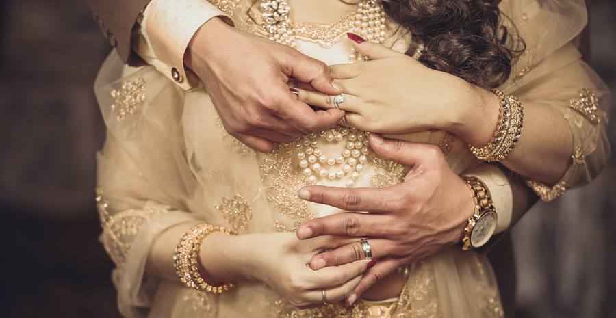 Photo of wedding rings in the hands of the young
